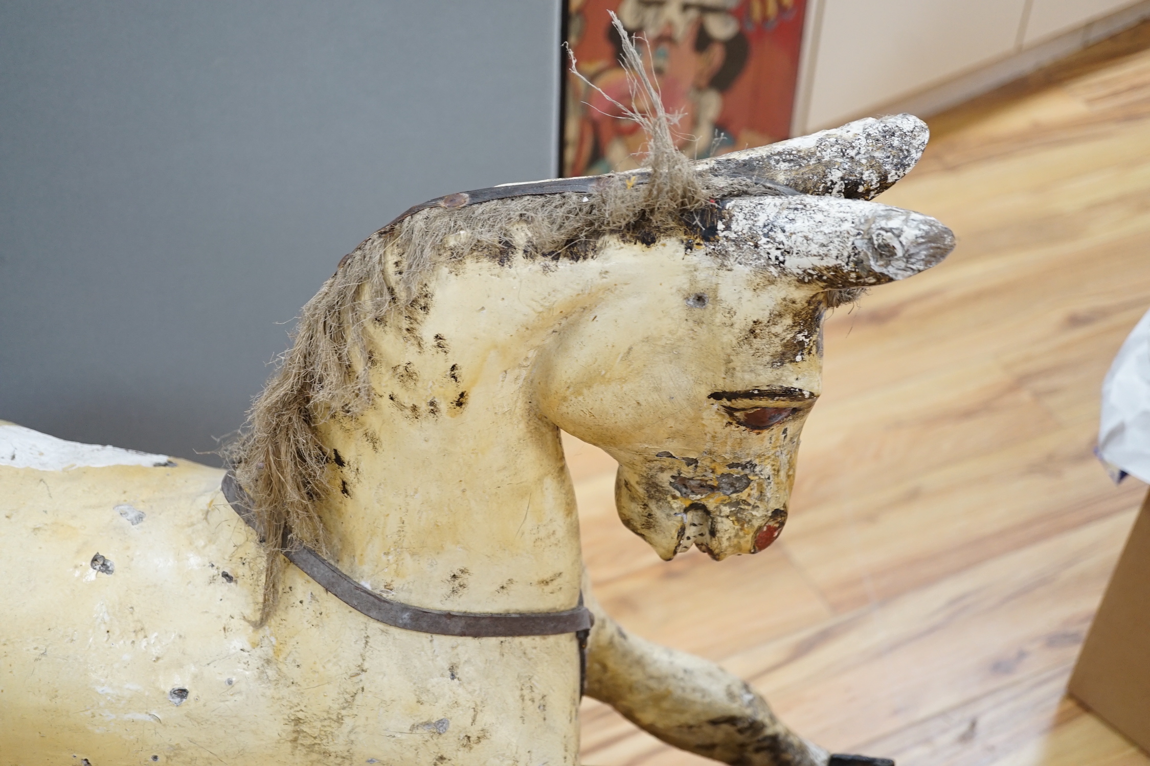 A Rocking horse on a wooden pedestal rocker, with plaster, composite body, height, 97cm, length 152cm